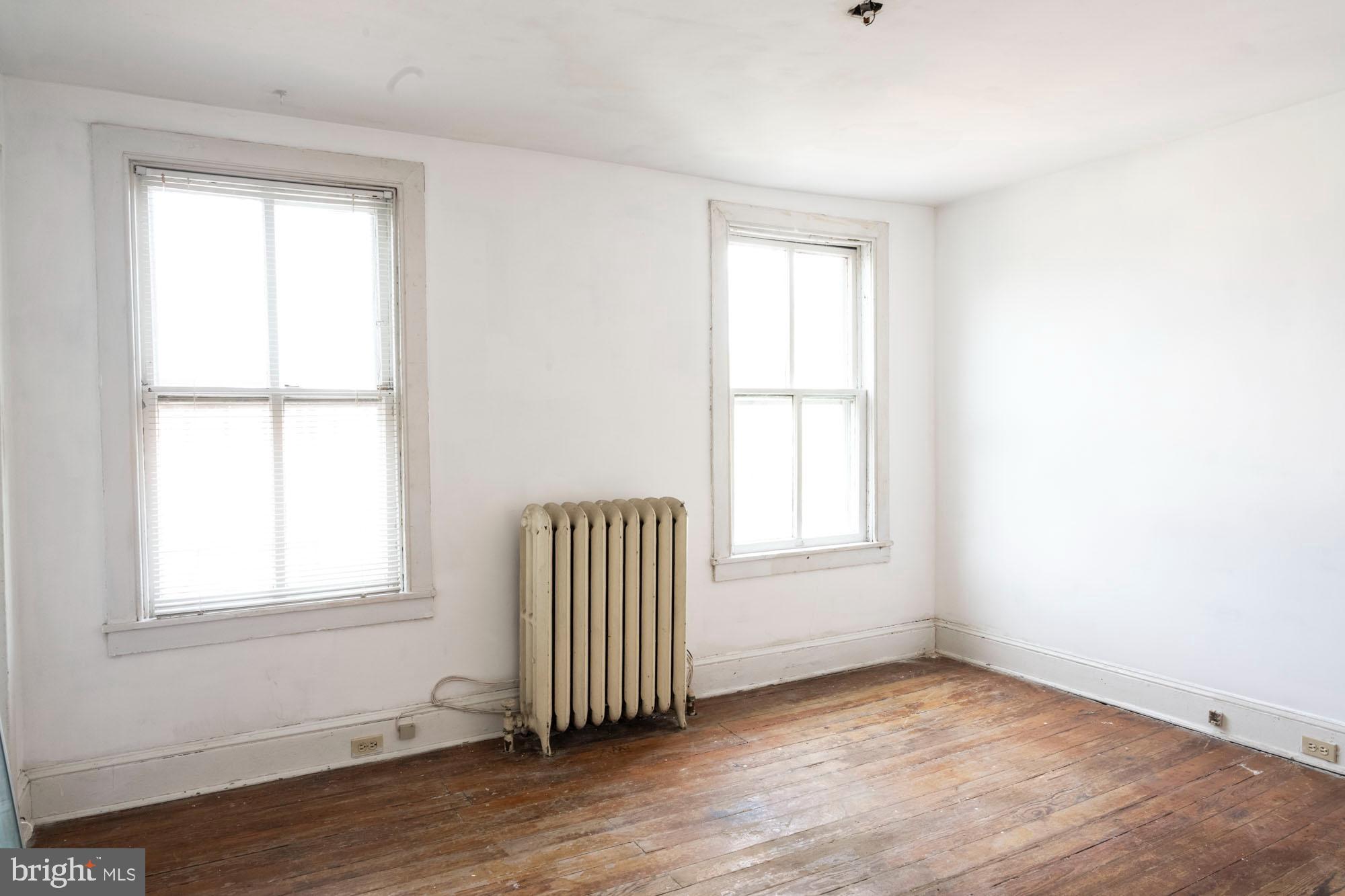 19 South Stricker Street Baltimore, MD 21223 - Photo 55 of 55 an empty room with wooden floor and windows