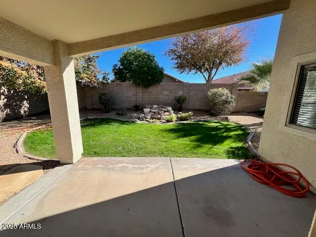 a view of a house with a small yard and a large tree