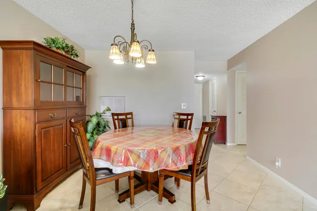 a view of a dining room with furniture and chandelier