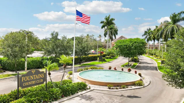 a view of a swimming pool with a dining table and chairs