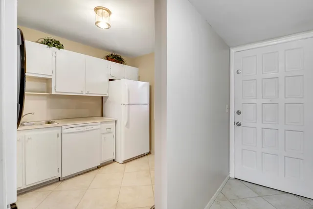 a kitchen with cabinets and white appliances