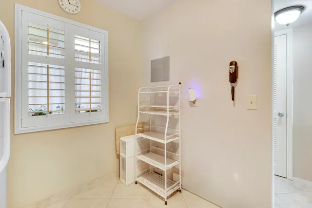 a front door view of a room with windows