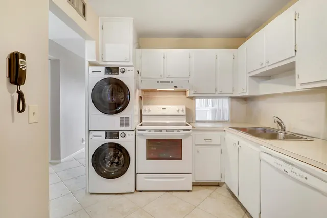 a kitchen with a stove top oven sink and cabinets