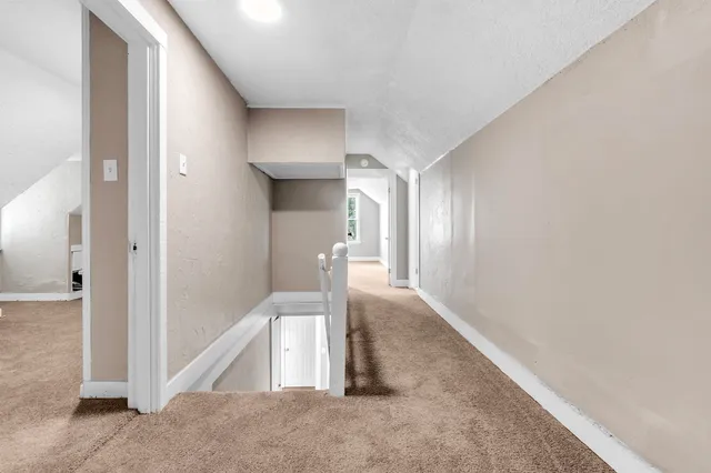 a view of a hallway with staircase