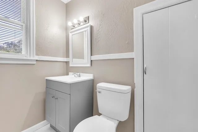 a white toilet sitting next to a bathroom sink