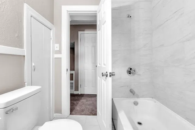 a bathroom with a toilet and a bathtub