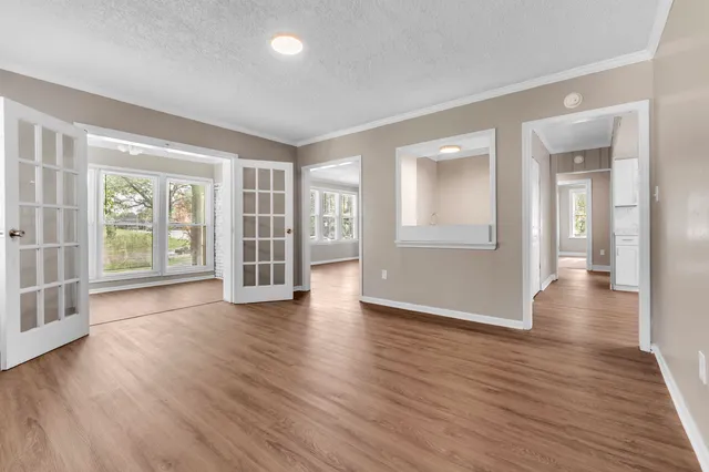 wooden floor in an empty room with a window