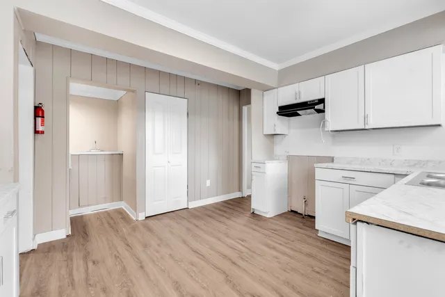 a kitchen with a refrigerator sink and cabinets