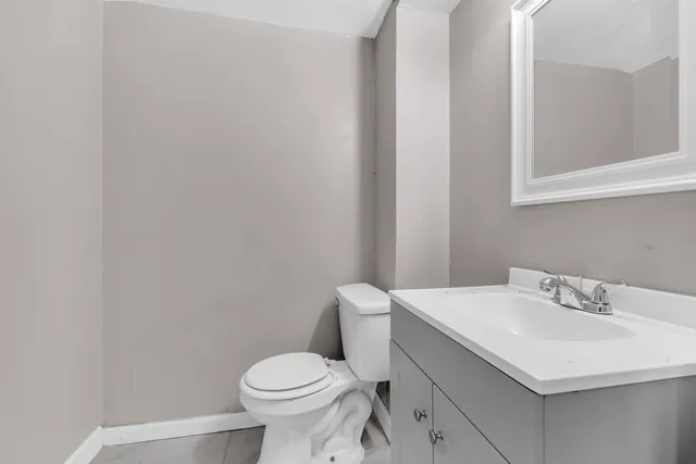 a bathroom with a sink toilet and a mirror