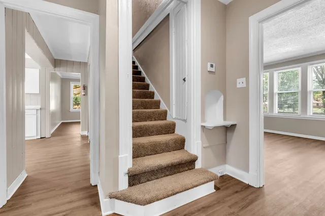 a view of entryway and hall with wooden floor