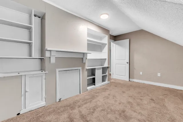 a view of a room with a closet and cabinet