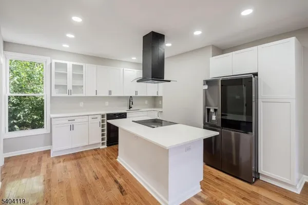a kitchen that has a sink a stove and a refrigerator