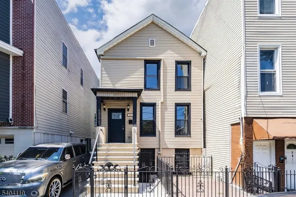 a front view of a house with parking space