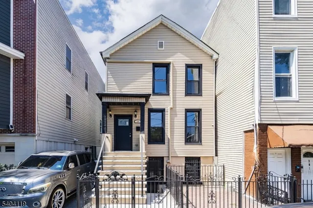 a front view of a house with parking space
