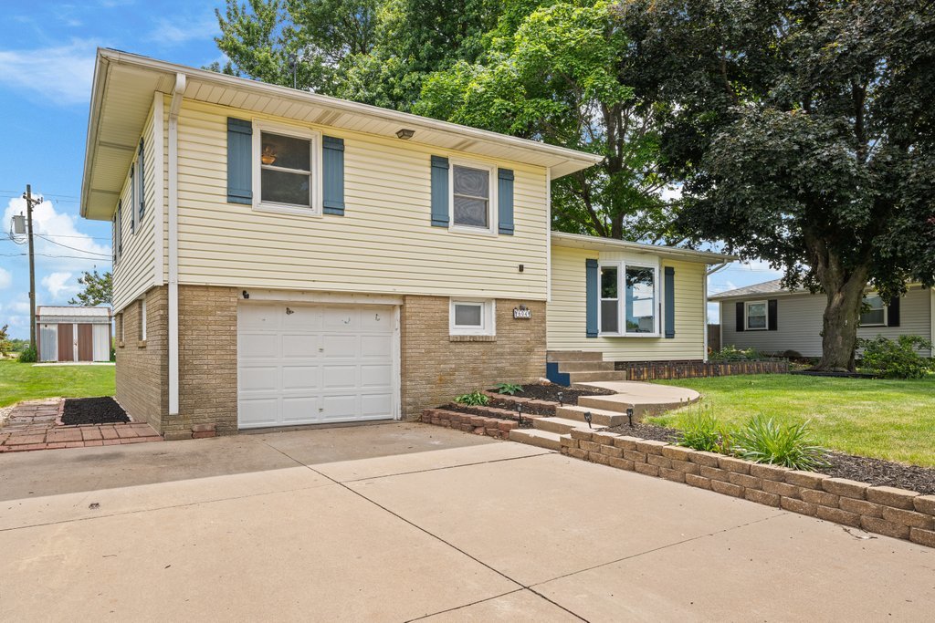 604 3rd Street Sherrard, IL 61281 - Photo 1 of 6 a front view of a house with a garden and trees