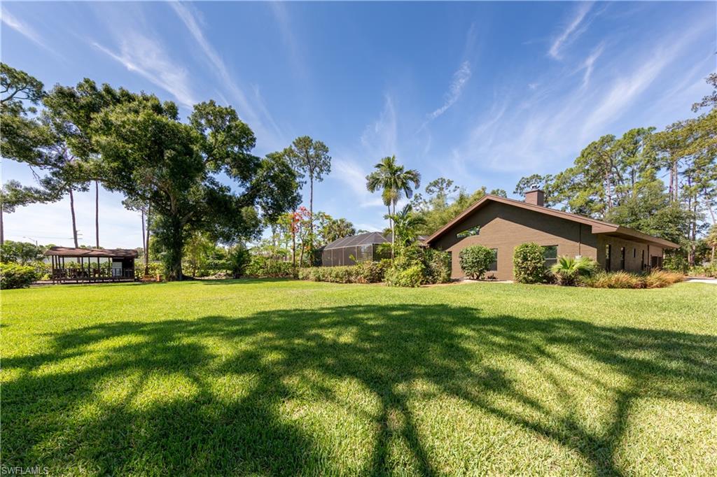 632 Hickory Road Naples, FL 34108 - Photo 15 of 20 a front view of a house with a yard