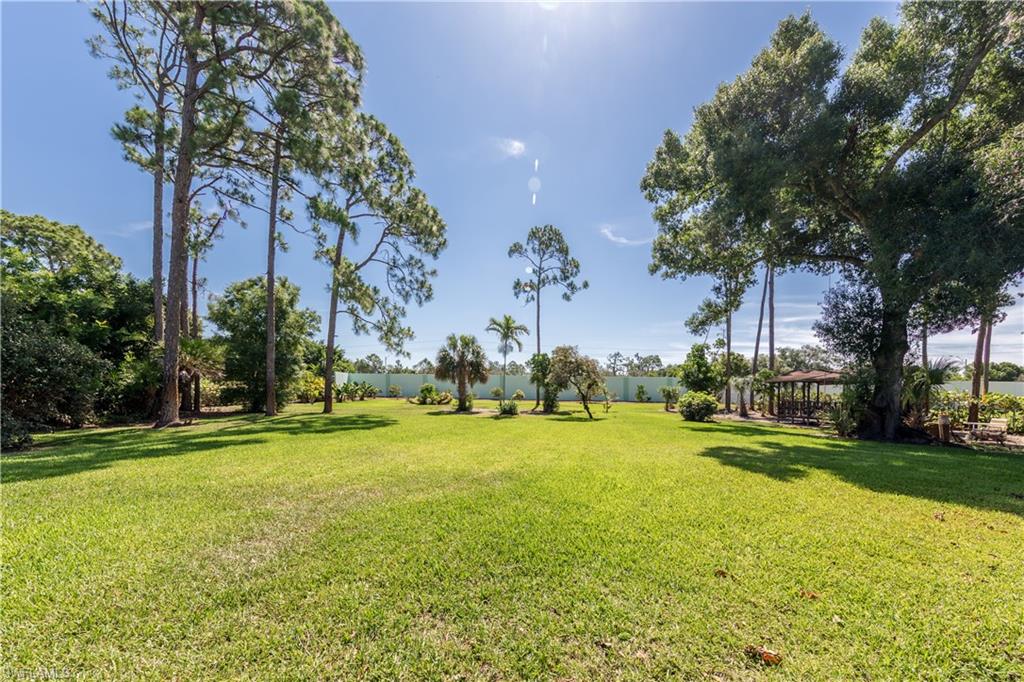 632 Hickory Road Naples, FL 34108 - Photo 16 of 20 a swimming pool with outdoor seating and yard