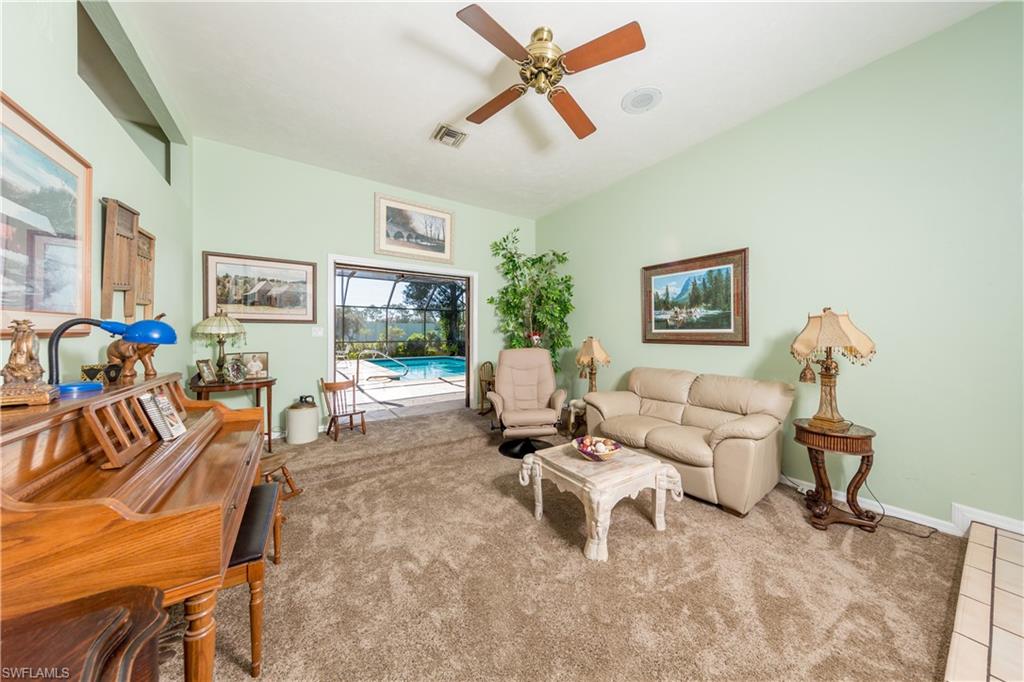 632 Hickory Road Naples, FL 34108 - Photo 2 of 20 a living room with furniture and a flat screen tv