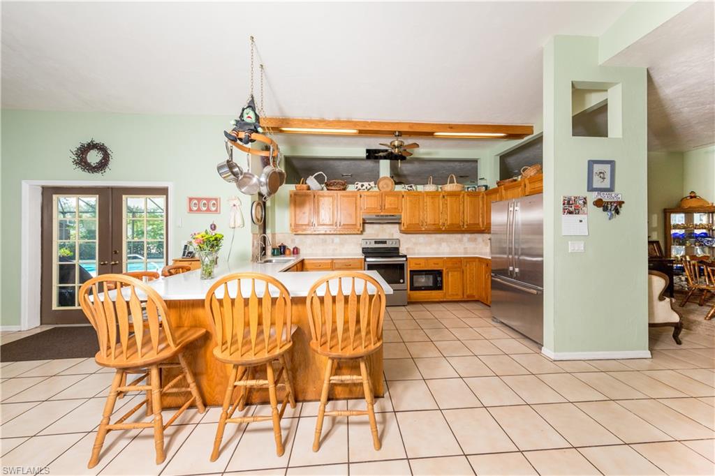 632 Hickory Road Naples, FL 34108 - Photo 3 of 20 a dining room filled with furniture and a chandelier