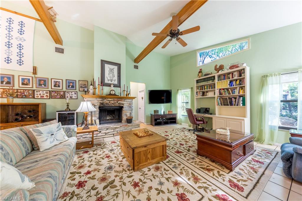 632 Hickory Road Naples, FL 34108 - Photo 5 of 20 a living room with furniture a fireplace and a flat screen tv