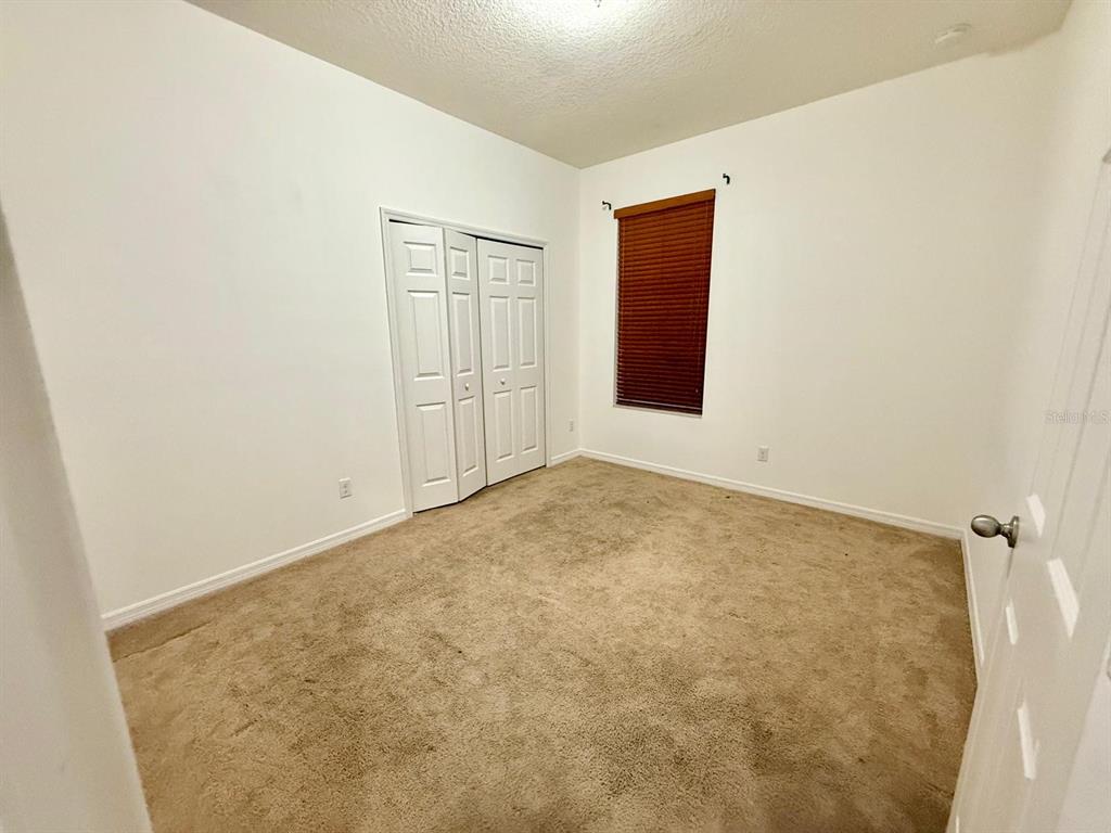 2716 Randal Way Kissimmee, FL 34743 - Photo 14 of 15 an empty room with windows