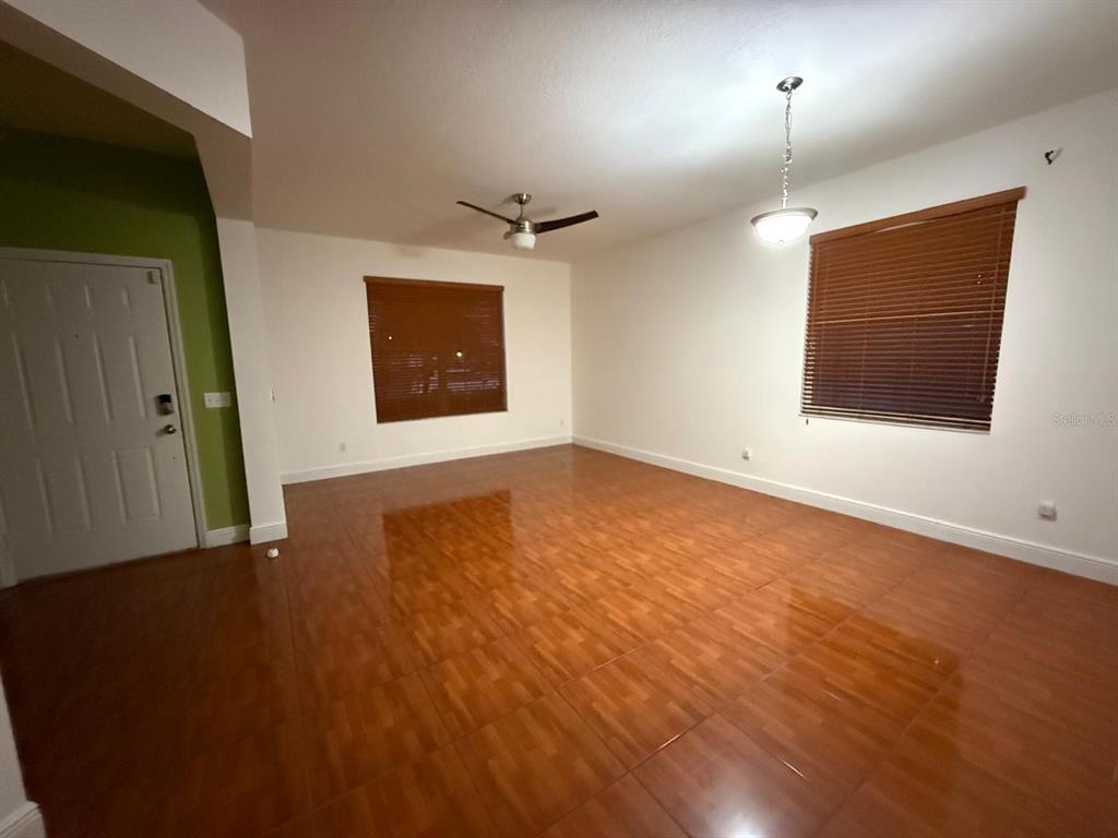 2716 Randal Way Kissimmee, FL 34743 - Photo 7 of 15 an empty room with wooden floor and windows