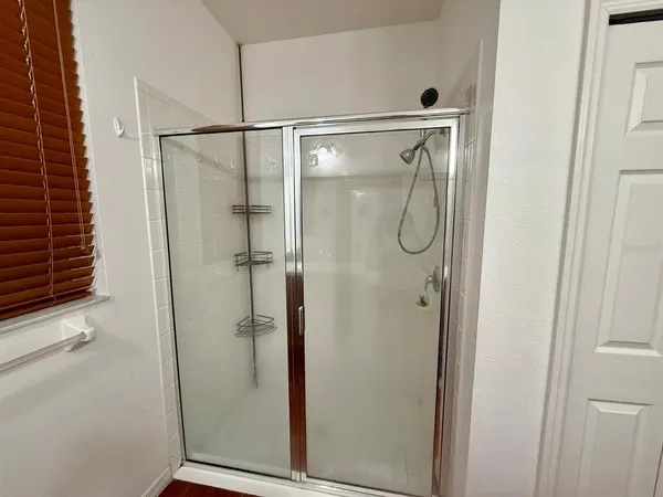a bathroom with a glass shower door