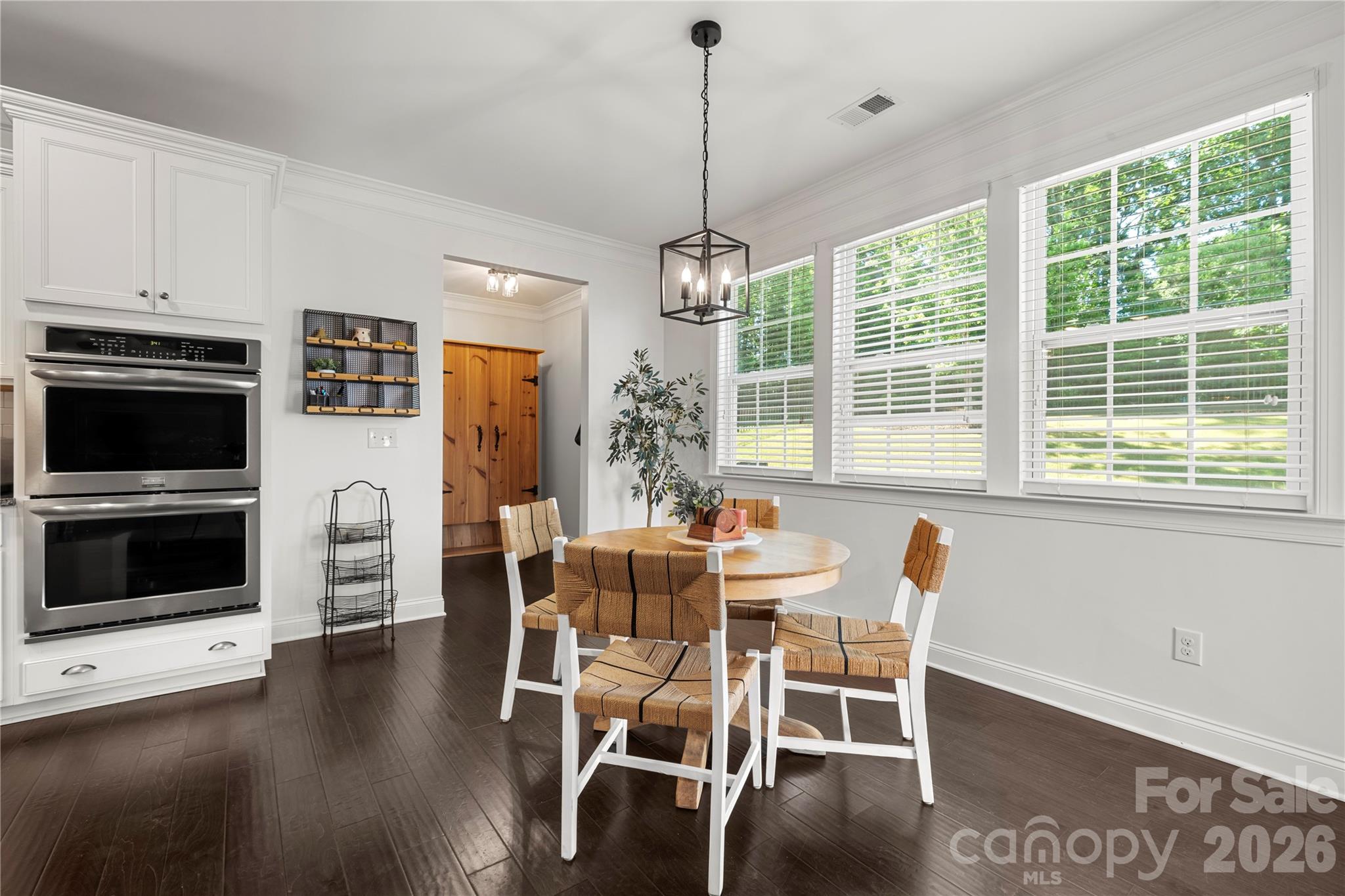 11266 Trailside Road Concord, NC 28027 - Photo 16 of 48 a dining room with furniture window fireplace and wooden floor