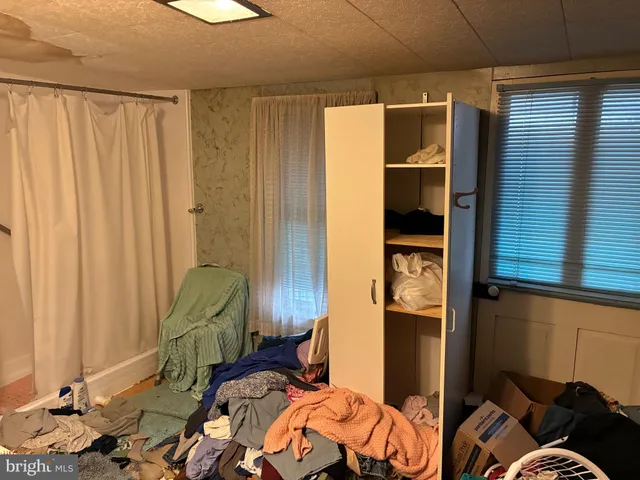 a living room with furniture and a toilet