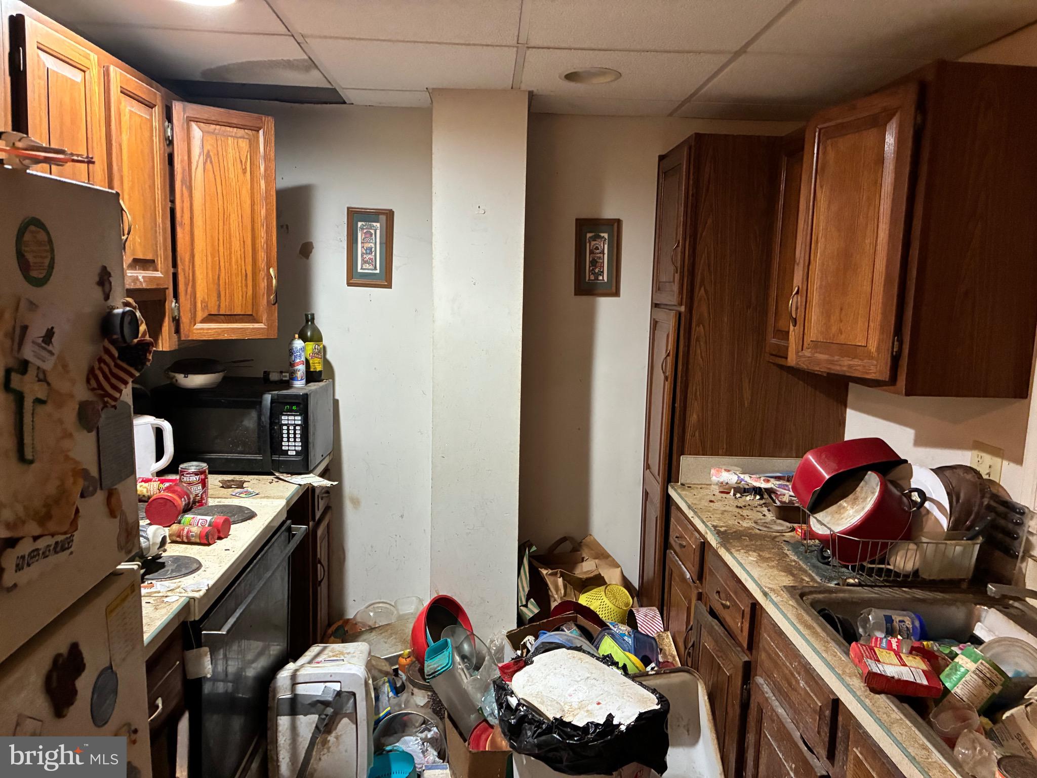 222 Main Street Denver, PA 17517 - Photo 7 of 32 a kitchen with a refrigerator and a stove top oven