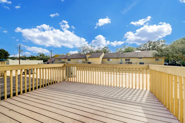 a view of a balcony with wooden floor