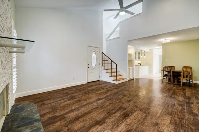 a view of a livingroom with wooden floor and staircase