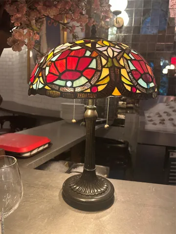 a view of swimming pool with red chairs