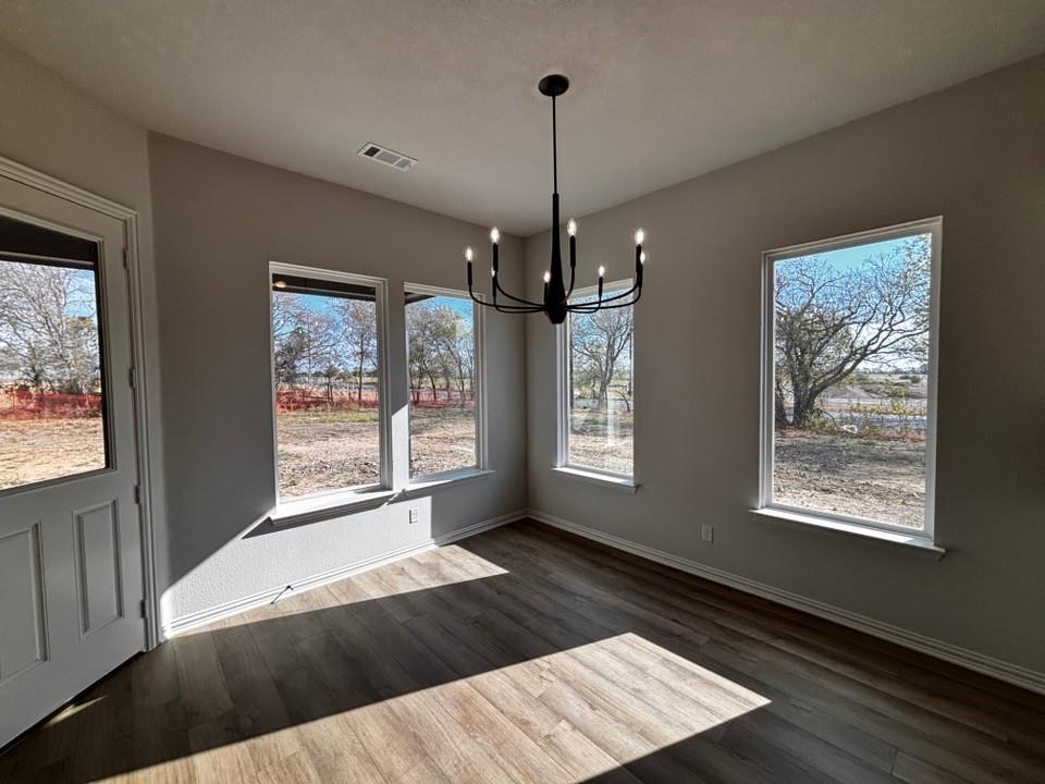 108 Pheasant Run Drive Rhome, TX 76078 - Photo 6 of 14 Wood-finish flooring with light neutral walls