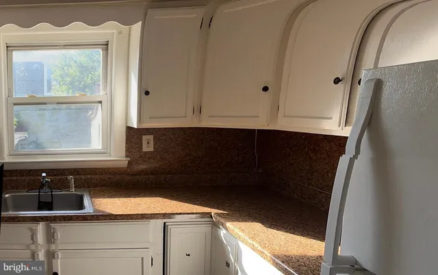 a kitchen with a sink and a window
