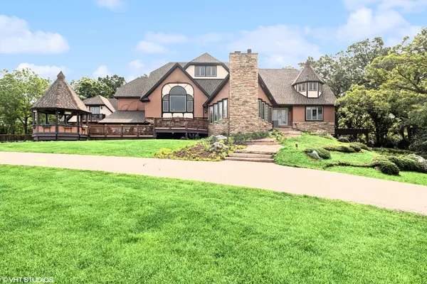 a front view of house with yard and green space