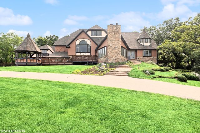a front view of house with yard and green space