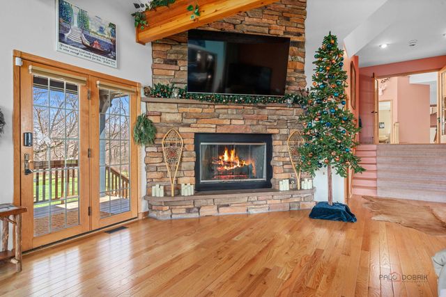 a dining room with furniture and a floor to ceiling window