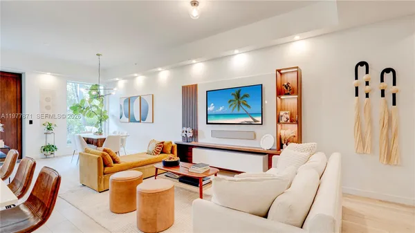 a living room with furniture and a chandelier
