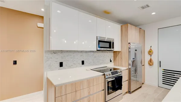 a kitchen with a sink stove and refrigerator