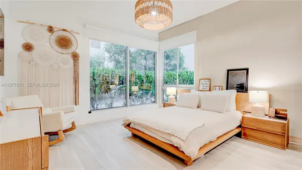 a bed room with a bed and a large window