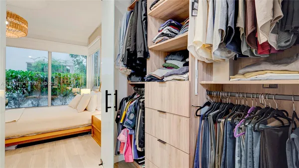 a living room with furniture and a book shelf