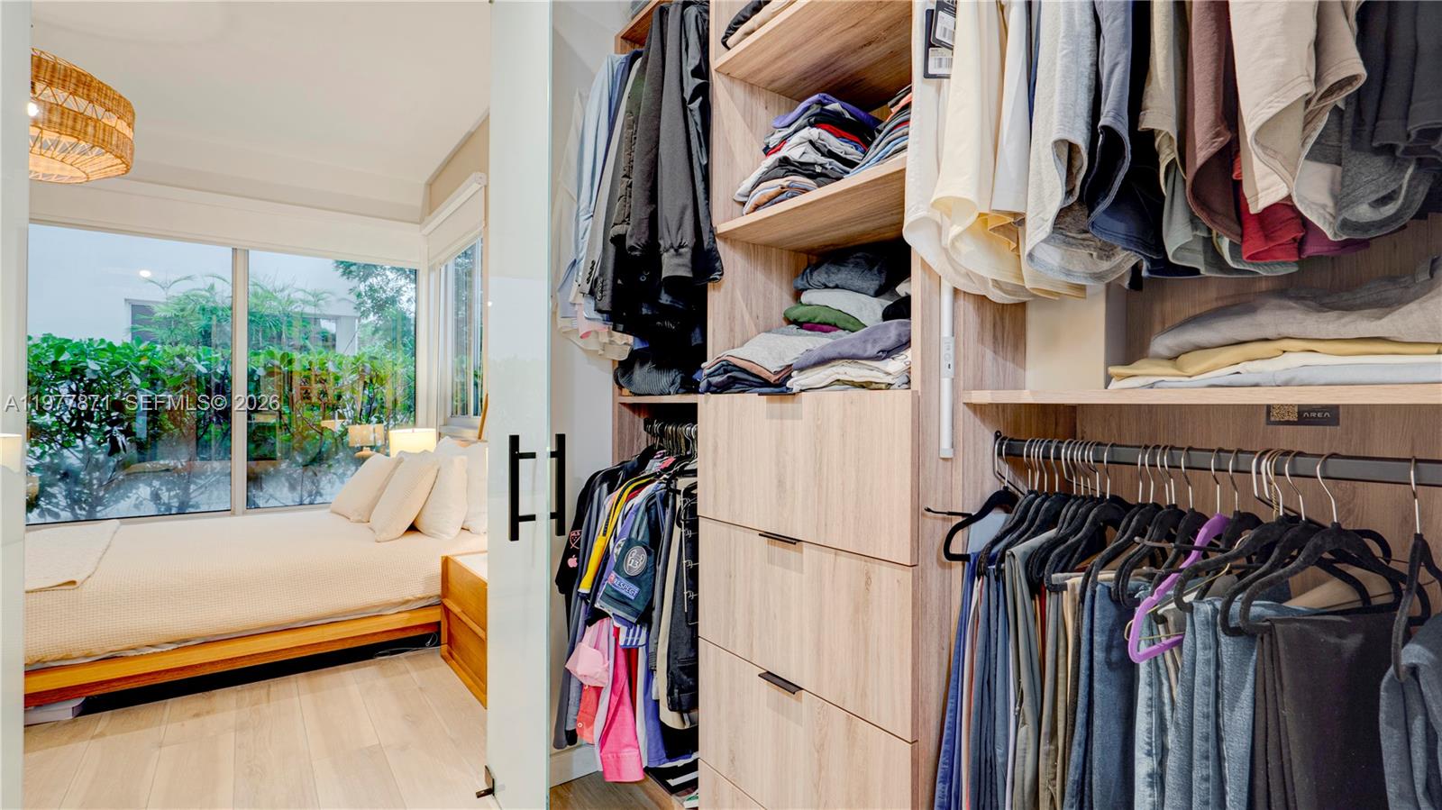 545 Southwest 11th Street, Unit 105 Miami, FL 33129 - Photo 28 of 43 a view of walk in closet with clothes and shoes