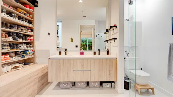 a bathroom with a sink vanity mirror and toilet