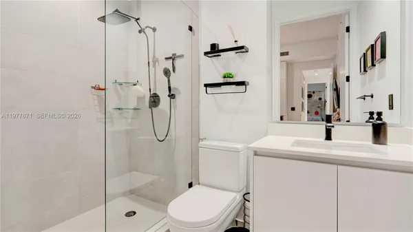 a utility room with dryer and white walls