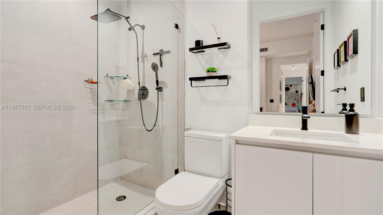 545 Southwest 11th Street, Unit 105 Miami, FL 33129 - Photo 35 of 43 a bathroom with a sink toilet and shower