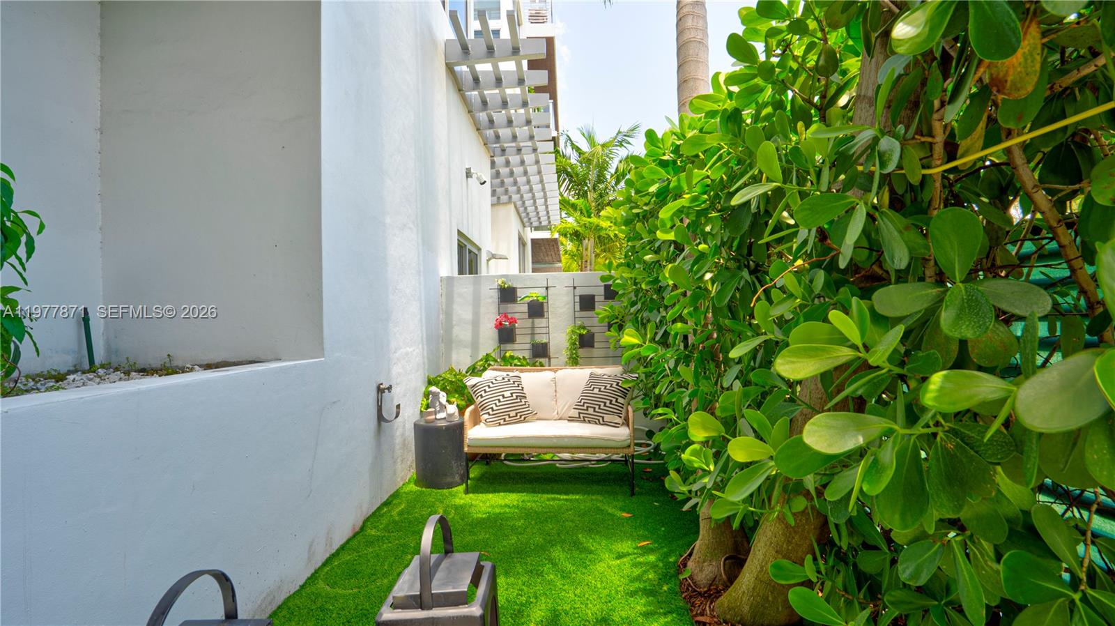 545 Southwest 11th Street, Unit 105 Miami, FL 33129 - Photo 4 of 43 a backyard of a house with table and chairs
