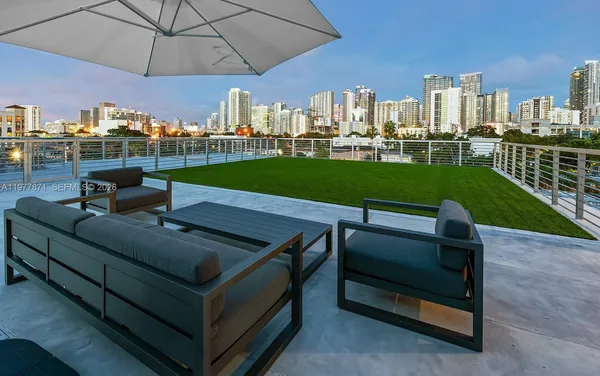 a view of a chairs in patio and a yard