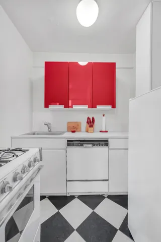 a kitchen with a sink cabinets and appliances