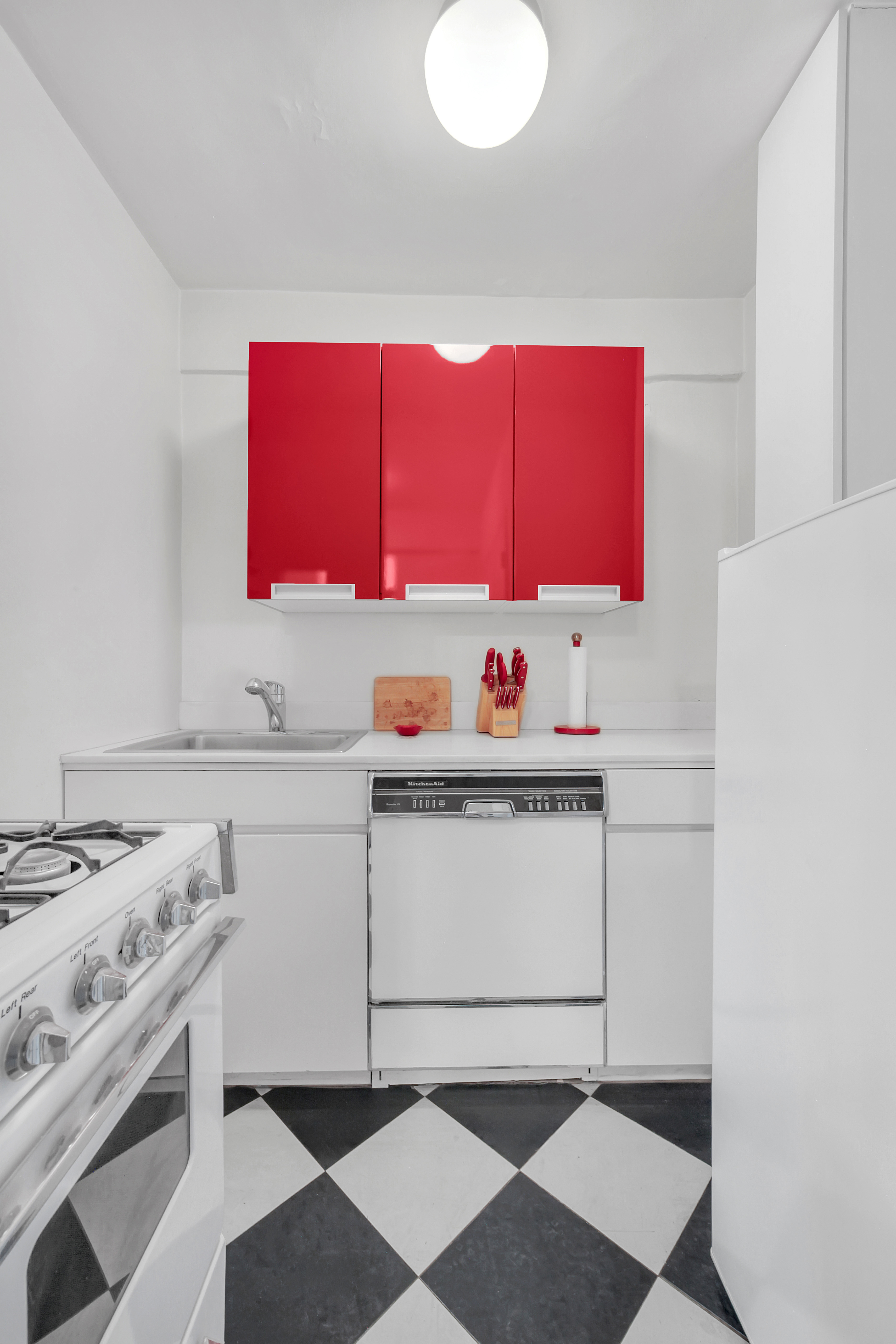 Undisclosed Address Manhattan, NY 10128 - Photo 4 of 9 a kitchen with a sink cabinets and appliances